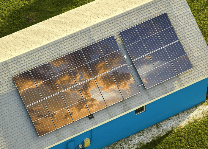 Energy Saving in Central Illinois with rooftop solar panels on a blue house.
