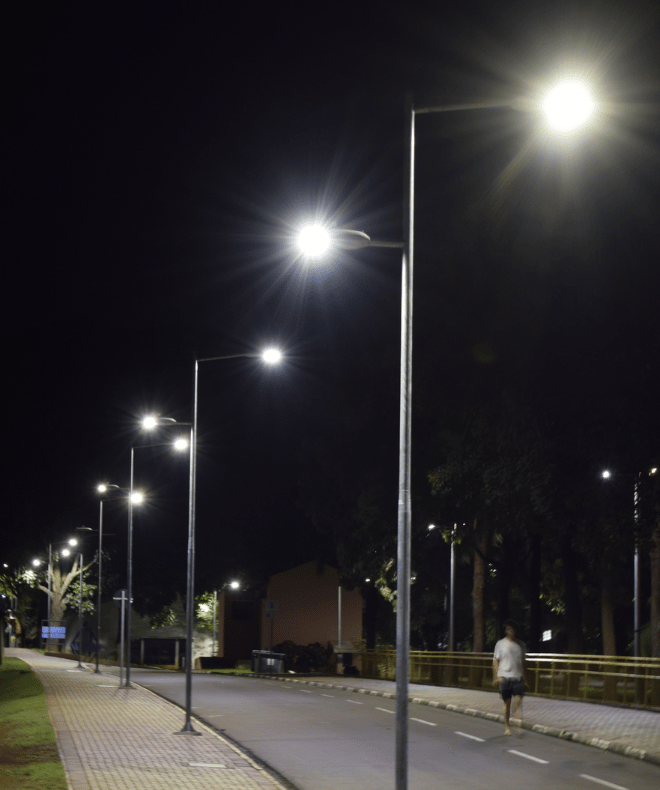 LED street and parking lot lights illuminating a roadway at night, providing consistent exterior lighting for pedestrian and vehicle visibility.